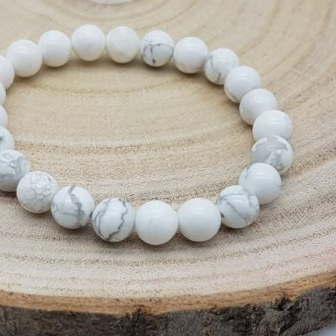 White beaded bracelet on a wooden surface